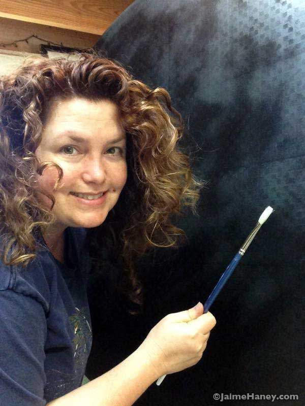 artist Jaime Haney holding paint brush