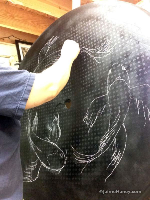 Me sketching the fish on the table with pastel chalk.