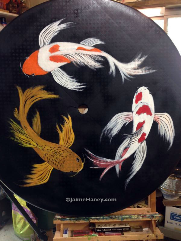 finished painted koi fish on upcycled plastic patio table top