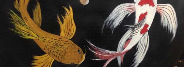 upcycled plastic patio table top with koi fish painted on it