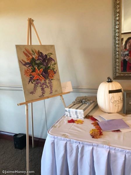 Bridal bouquet painting on easel at gift table